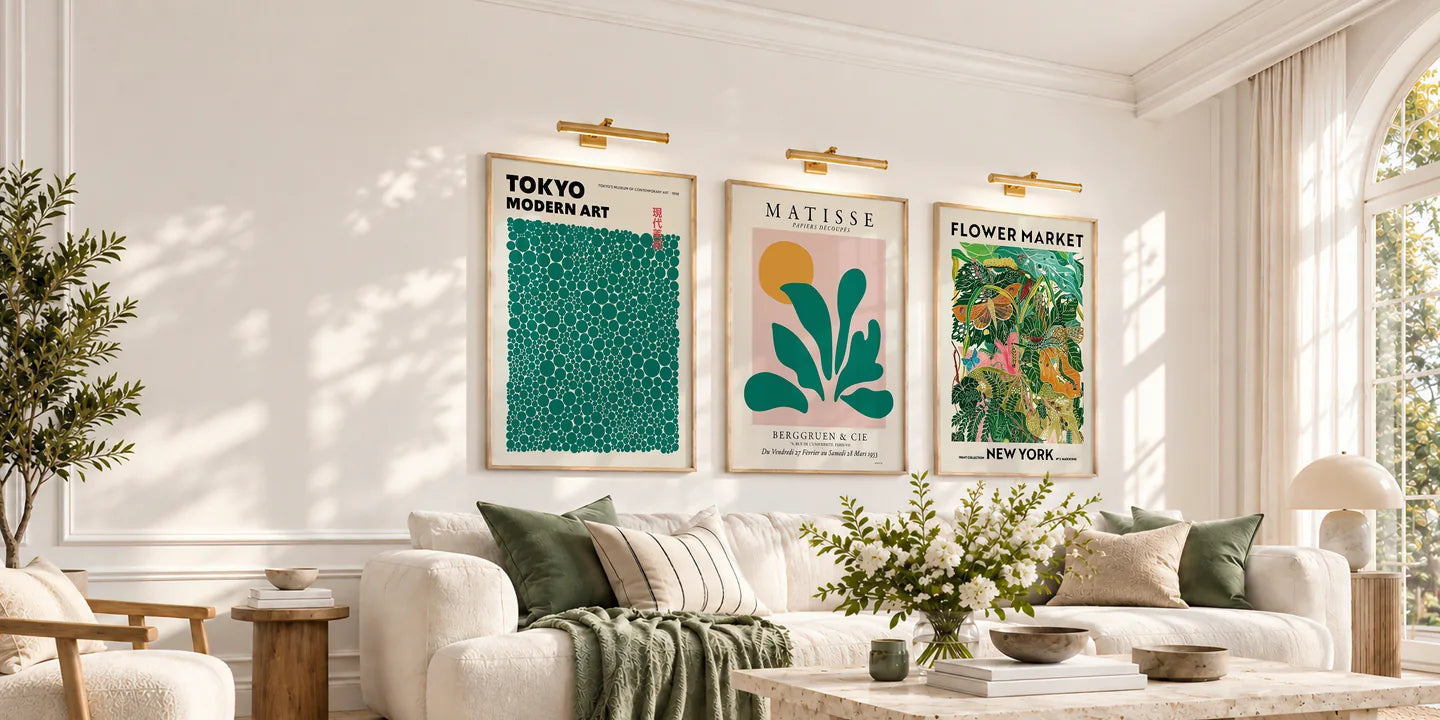 Green and colourful framed art above a cream sofa in a sunlit living room